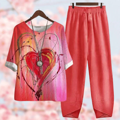 Elegante tweedelige set met vintage bloemenprint, losse top met korte mouwen en high-waist broek, stijlvol en comfortabel.