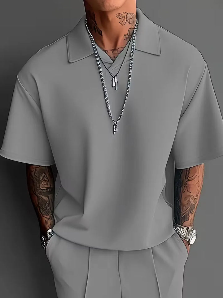 Zakelijk casual herenpak, tweedelig met korte mouwen en rechte broek, perfect voor werk.