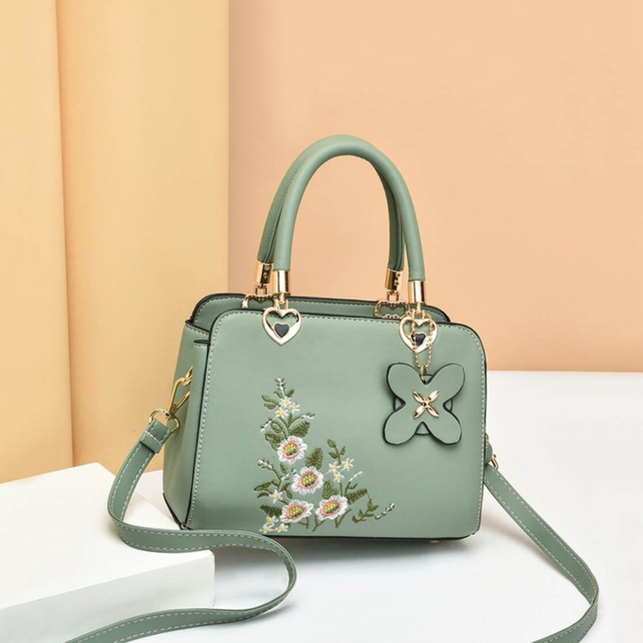 Chique Flora dames crossbody tas, een modieuze handtas met verfijnd borduurwerk detail.