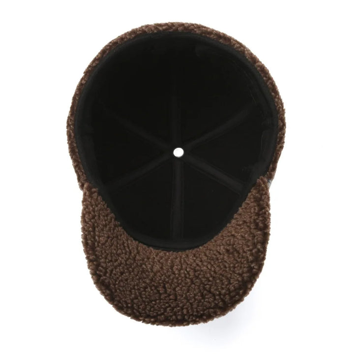 Detail van zwarte heren winterpet: hoogwaardige leerlook stof met zachte voering en oorkleppen. Duurzaam accessoire.
