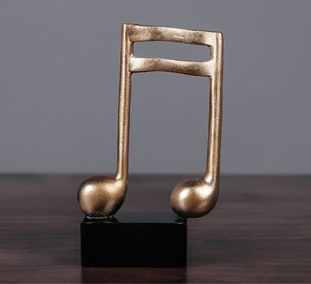 Muzikaal gouden muzieknoot beeldje, een elegant woonaccessoire; ideaal als cadeau of interieurdecoratie.
