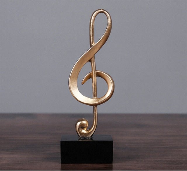 Elegant gouden muzieknoot beeldje, perfect als muzikaal woonaccessoire voor bureau of plank decoratie.