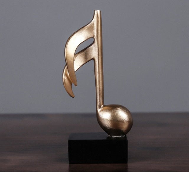 Decoratief gouden muzieknoot ornament, een stijlvol interieurstuk voor kast of plank decoratie.