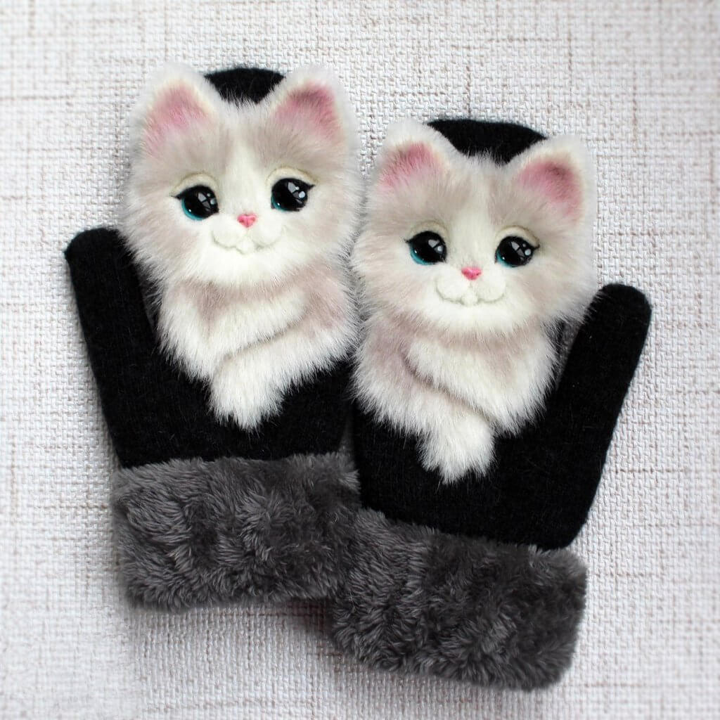 Detail van handgebreide panda dierenwanten. Zacht en warm, perfect voor meisjes en dames in de winter.