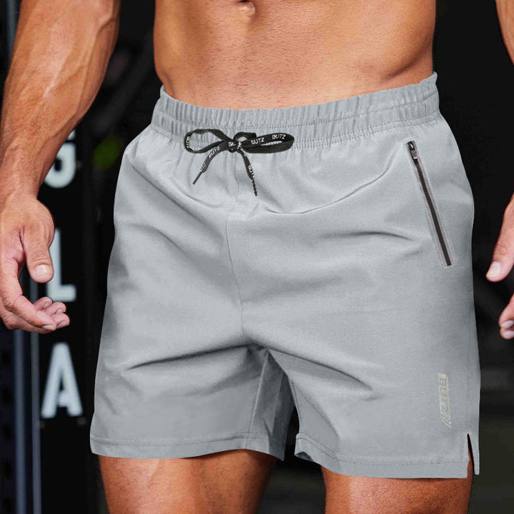 Donkergrijze trainingsshorts voor heren, met veilige ritszakken en elastische tailleband.