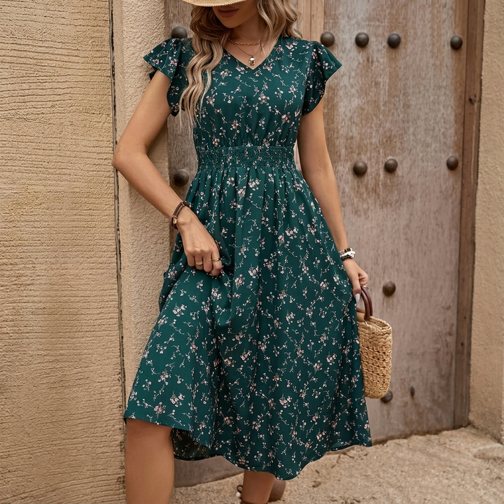 Dames A-lijn jurk in petrol met vrolijke bloemenprint, ideaal voor zomerse elegantie en comfort.