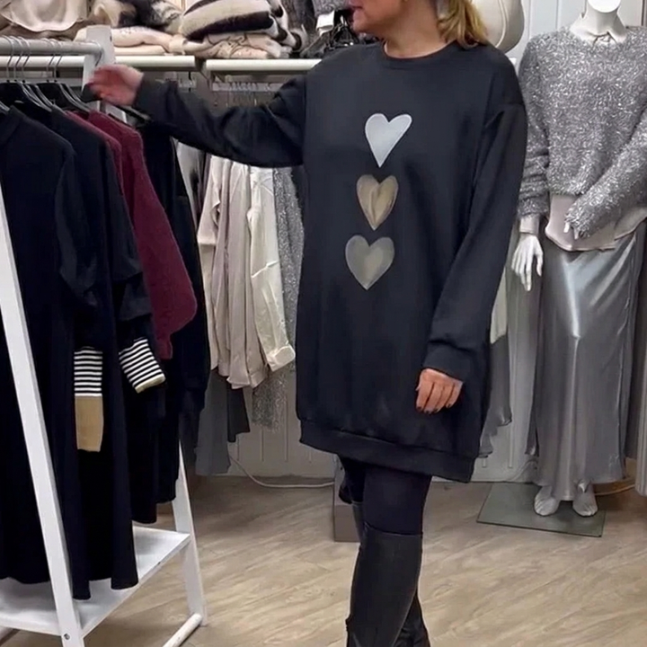 Veelzijdige zwarte dames jurk met hartjesprint en lange mouwen, een trendy oversized sweatshirtjurk.