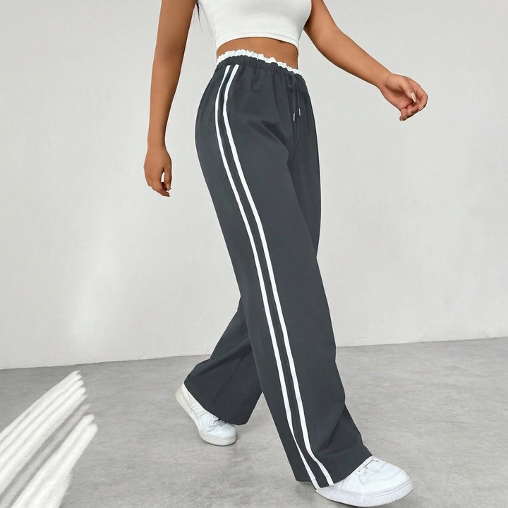 Dames comfortabele sportbroek met wijde pijpen, streetwear look en elastische taille, met stijlvolle strepen.