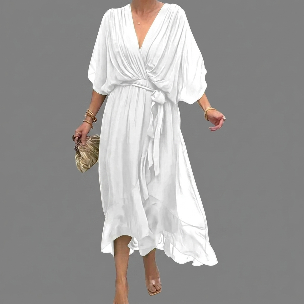 Elegante damesjurk met vleermuismouwen, losse pasvorm en asymmetrische zoom. Comfortabel en stijlvol.