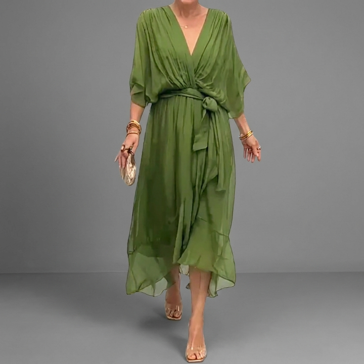 Damesjurk met unieke vleermuismouwen en asymmetrische zoom. Elegante, comfortabele pasvorm voor dames.