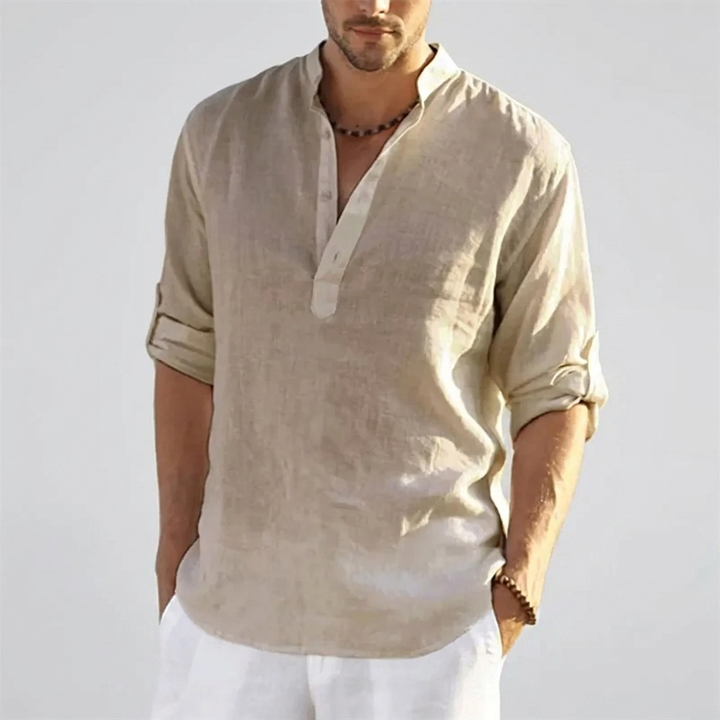 Man draagt comfortabel bruin Henley overhemd met effen design, relaxte pasvorm voor zomerse dagen.