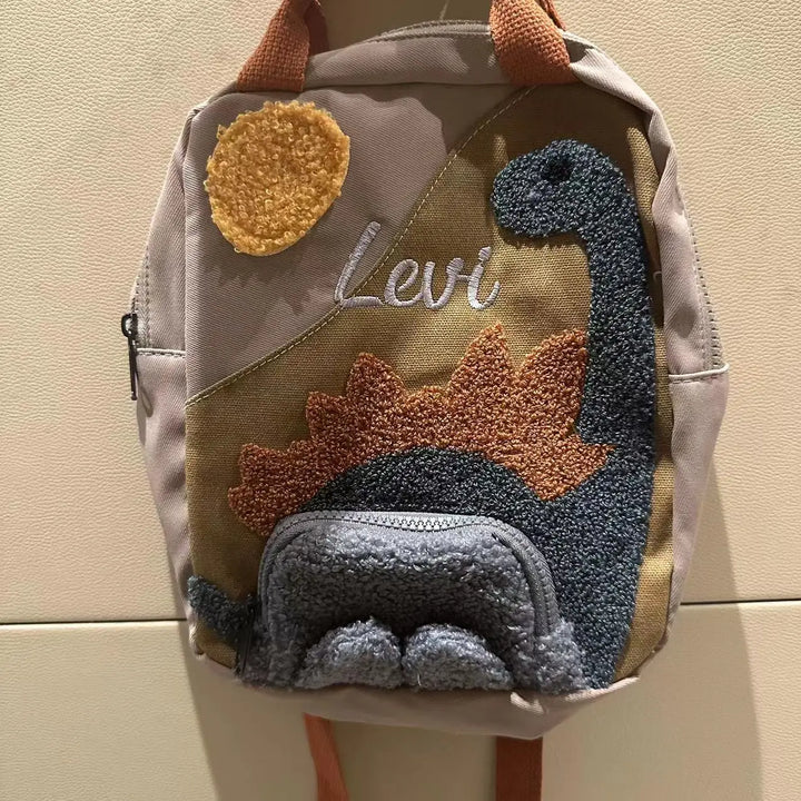 Stoere canvas kinderrugzak met kleurrijke dinosaurus print, ideaal voor avontuurlijke jongens en meisjes.