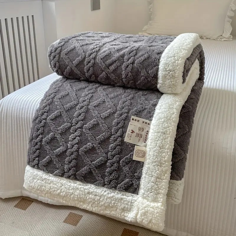Hoogwaardige sherpa deken met rijke textuur; een premium zachte en warme woondeken voor ultiem comfort en ontspanning thuis.