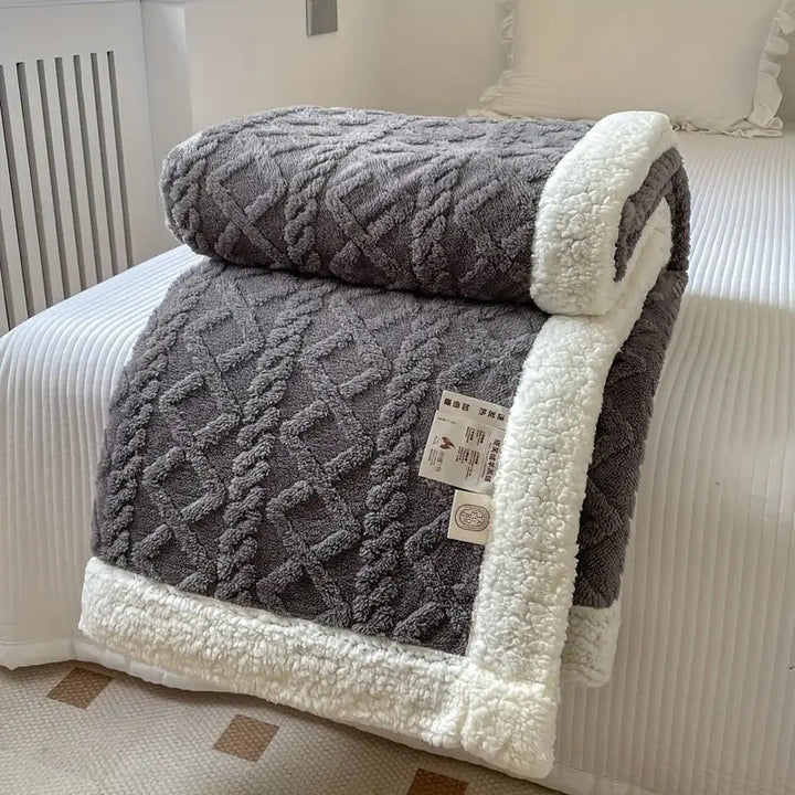 Hoogwaardige sherpa deken met rijke textuur; een premium zachte en warme woondeken voor ultiem comfort en ontspanning thuis.