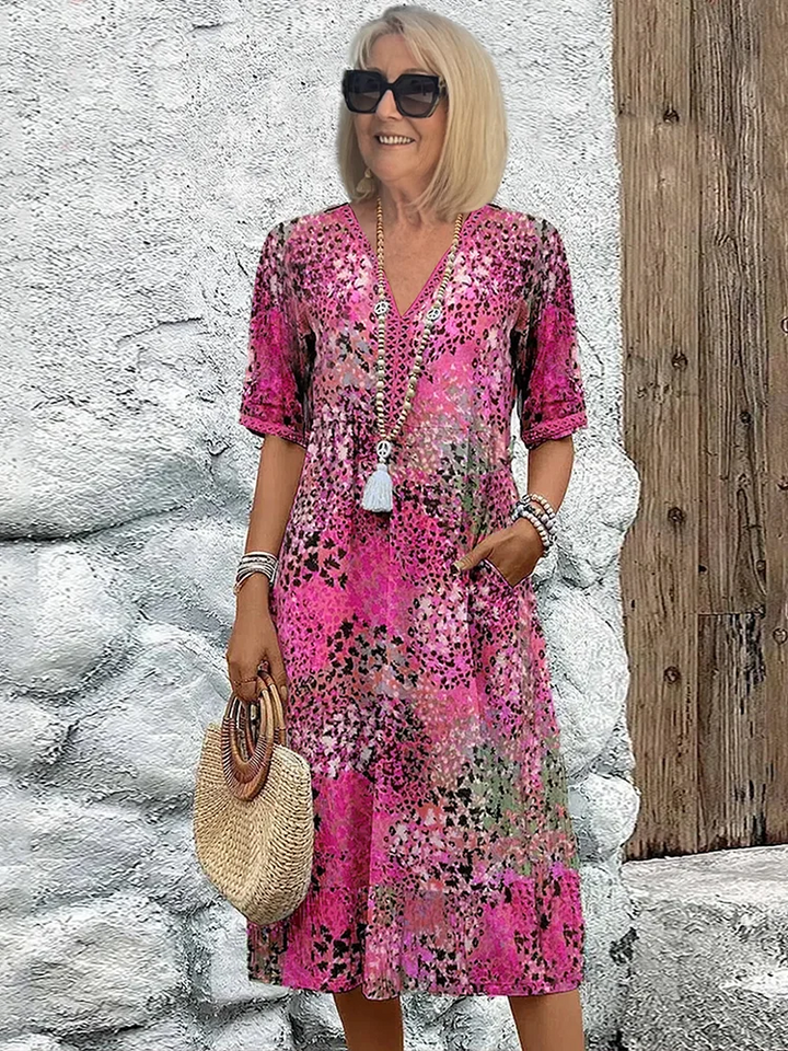 Comfortabele A-lijn midi jurk met levendige print, V-hals en praktische zakken. Een must-have dames jurk.