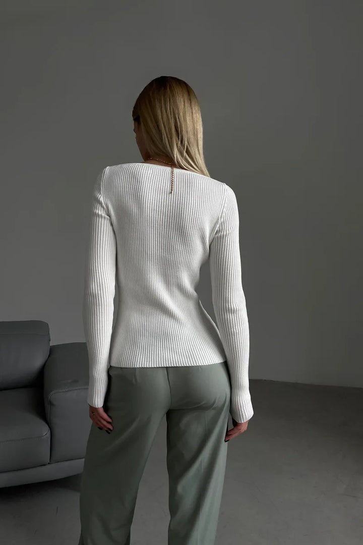 Detailopname van de fijne ribstof van een comfortabele off shoulder damestrui, perfect voor de herfst.