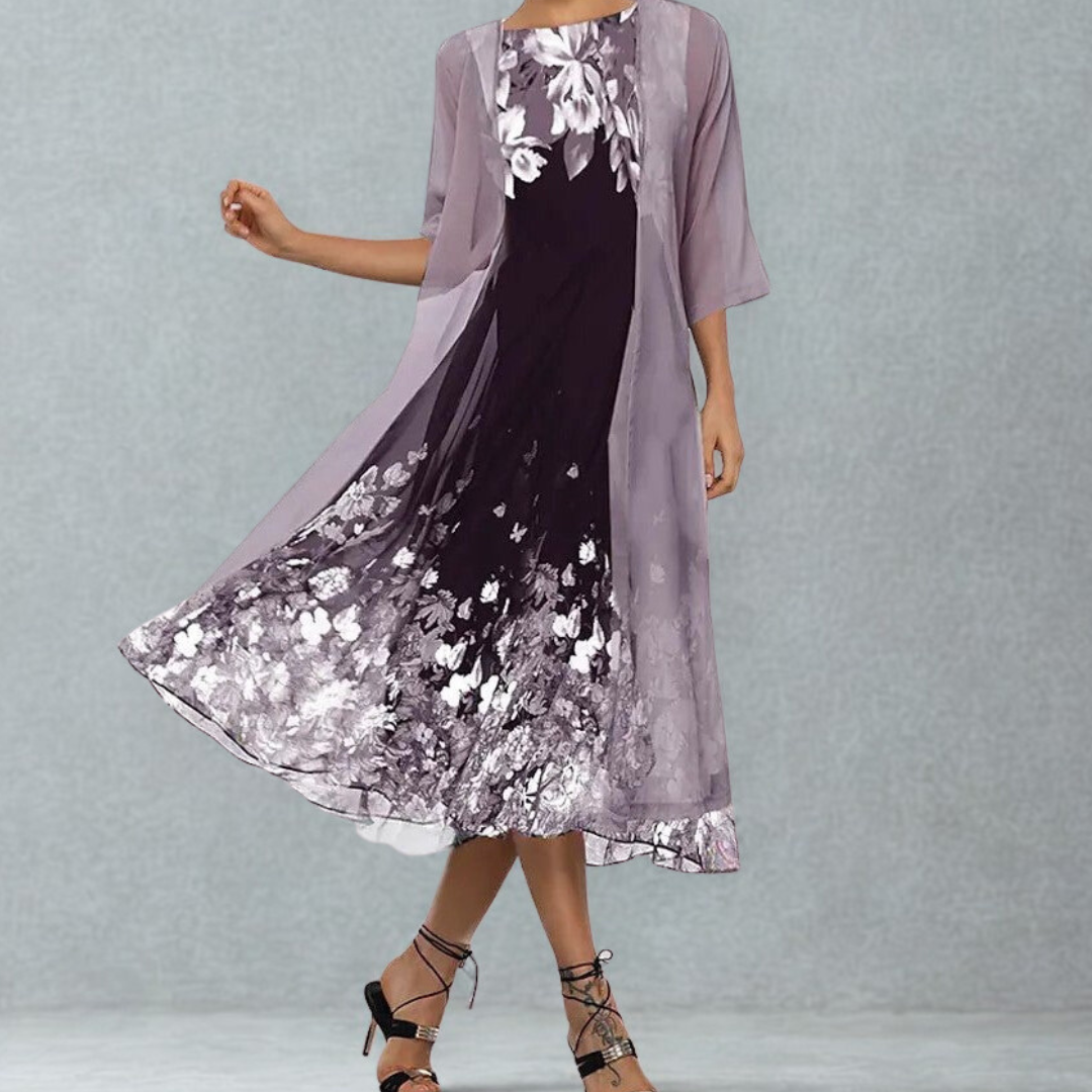 Elegante dames midi jurk met bloemenprint en bijpassend jasje. Perfecte donkerpaarse jurkenset voor lente/zomer.