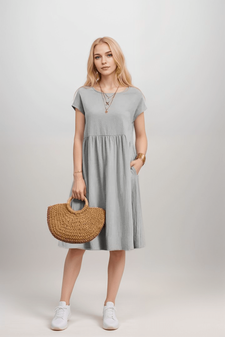 Elegante dames midi jurk met A-lijn silhouet, korte mouwen en handige zakken; perfect voor casual of chique gelegenheden.