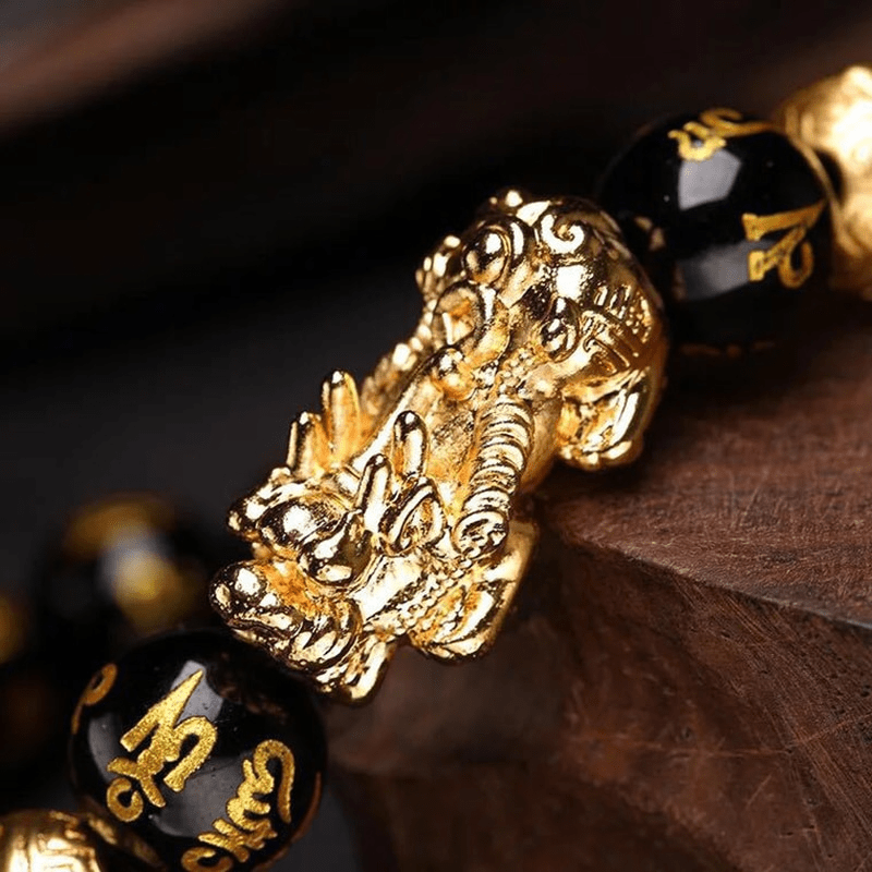 Zwarte obsidiaan edelsteen armband met Pi Xiu symbool. Unisex sieraad voor spirituele rijkdom, bescherming en geluk.