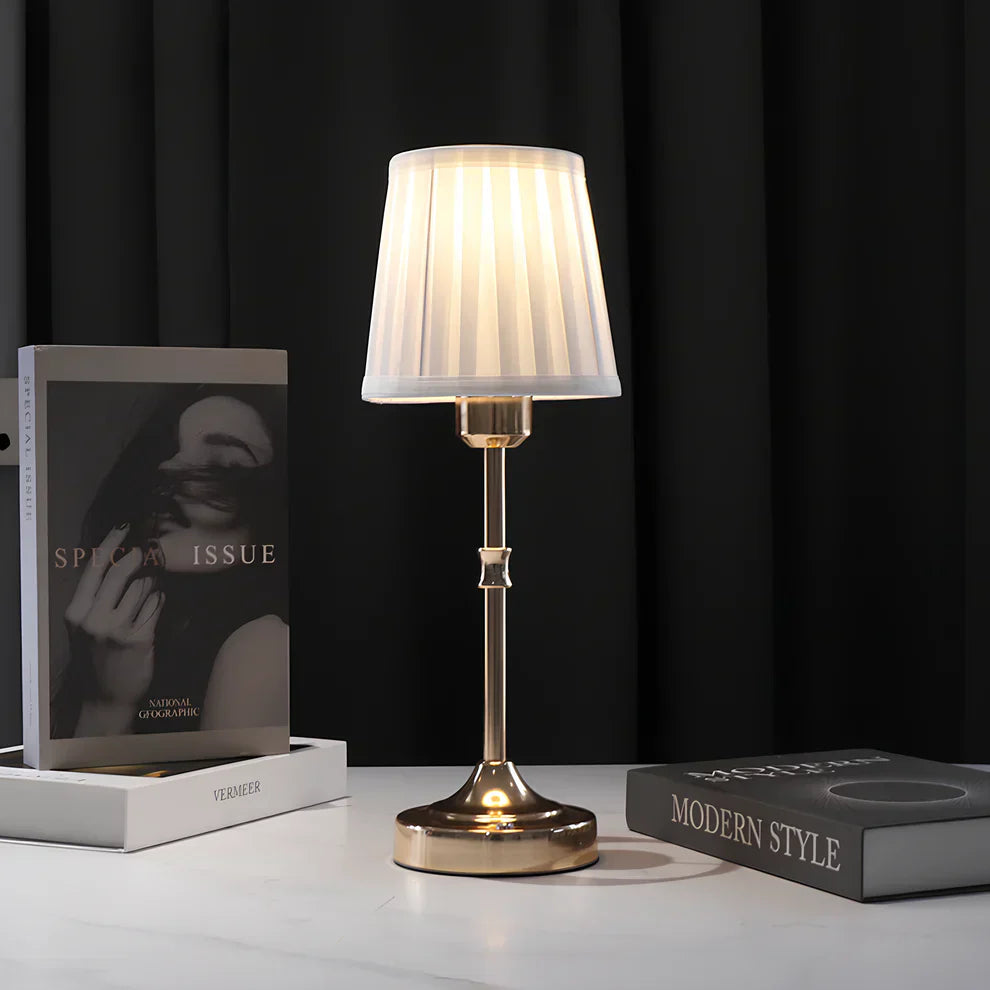 "Klassieke tafellamp met metalen frame en stoffen kap in een interieur, draadloos met drie lichtstanden."