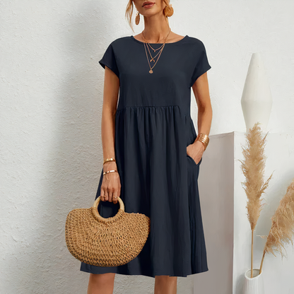 "Knielange zomerjurk dames in katoen met zakken, elegante en comfortabele pasvorm voor casual en feestelijke momenten."