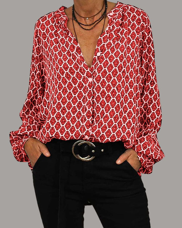 Stijlvolle damesblouse met modieus geometrisch patroon en klassieke V-hals, veelzijdig en trendy.