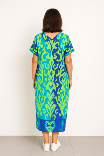 "Levendige bedrukte kaftan maxi jurk met tropisch dessin, V-hals en korte mouwen, ideaal voor zomerse dagen en avonden."