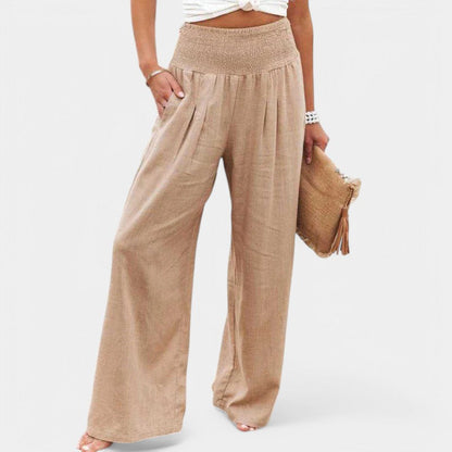 "Luchtige linnen broek met hoge taille en flared pijpen, ideaal voor zomerse dagen, in een elegante beige tint."