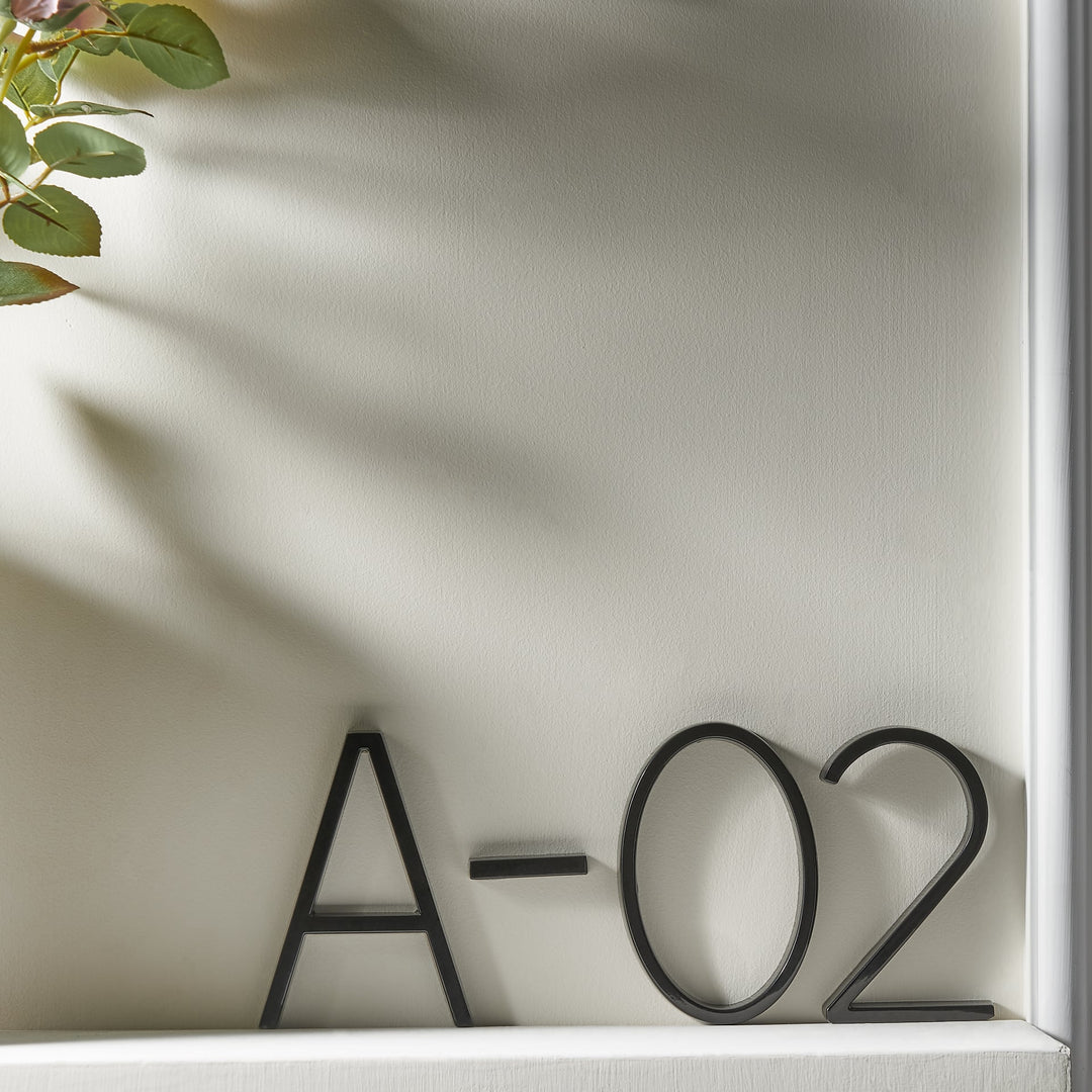 Elegant zwart huisnummer met zwevend effect, verrijkt de buitendecoratie van uw woning.