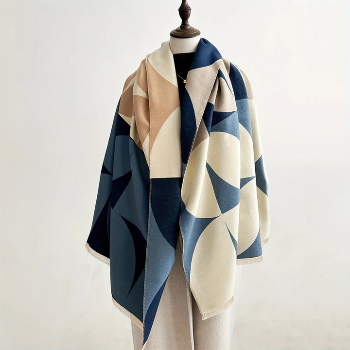 Omkeerbare poncho sjaal voor dames, combineert warmte en stijl. Een veelzijdig mode accessoire.