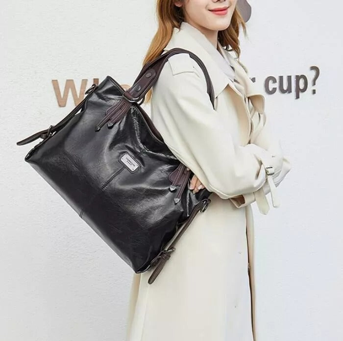 Bruine vintage leren dames handtas, zacht en ruim, te dragen als schoudertas of crossbody.