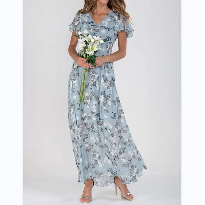 Trendy dames maxi-jurk met levendig bloemmotief, A-lijn pasvorm en comfortabele vlindermouwen. Perfect voor de zomer.