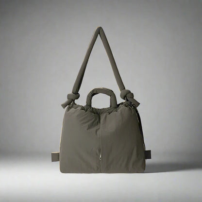 "Stijlvolle puffer handtas in beige met ruim design en comfortabele handgrepen voor vrouwen, perfect voor dagelijks gebruik."