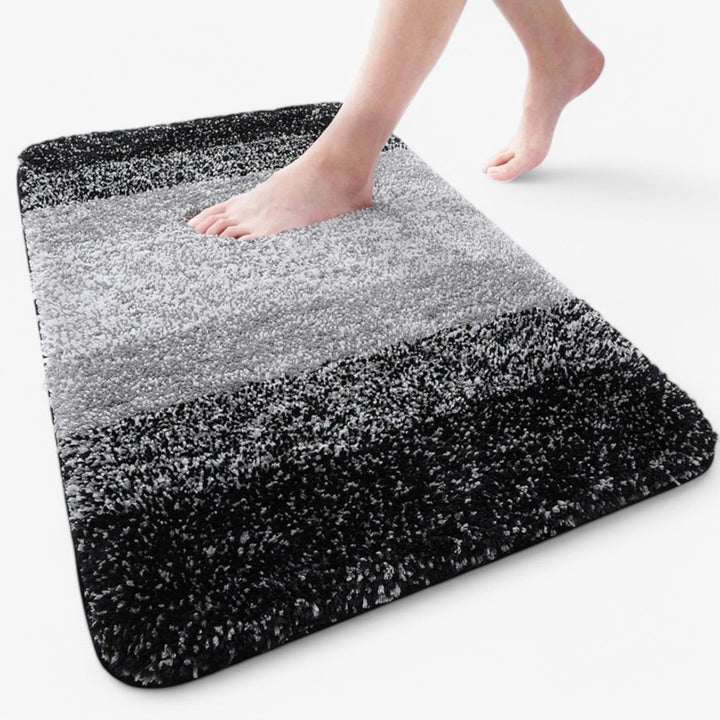 Super absorberende en sneldrogende badmat met antislip functie, essentieel voor een droge badkamer.