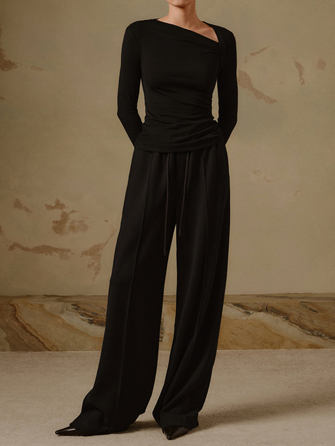 Modieuze getailleerde dames top met lange mouwen en unieke asymmetrische halslijn. Trendy basistop.