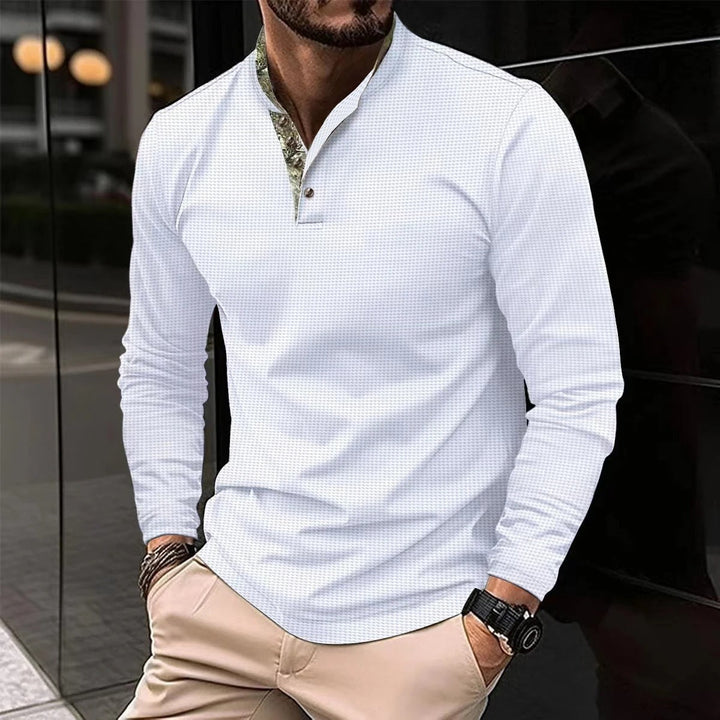 Man draagt Heren Polo Noah: Stijlvol poloshirt, ideaal voor zomerse dagen. Perfecte combinatie van casual en zakelijk.
