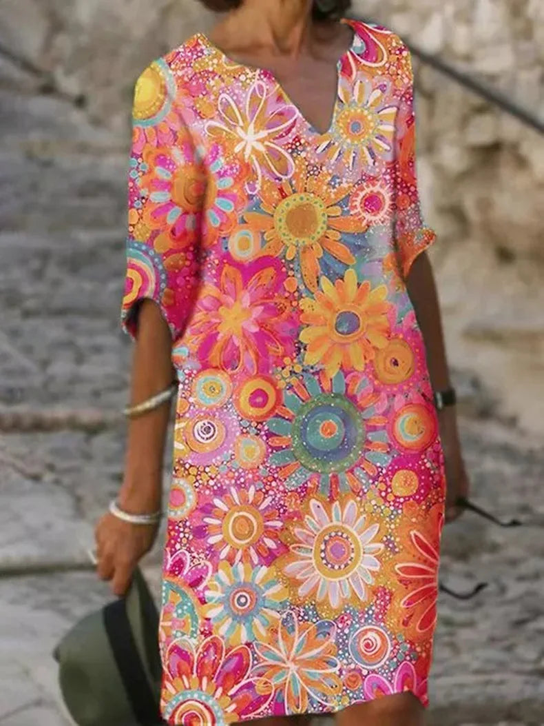 "Vrouwelijke boho jurk met levendige bloemenprint, elegante V-hals en vloeiende stof, ideaal voor stijlvolle zomerdagen."