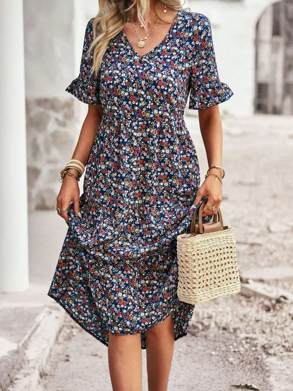 "Zomerjurk met bloemenpatroon en V-hals in abrikoos; elegante, casual damesjurk voor een stijlvolle zomerlook."