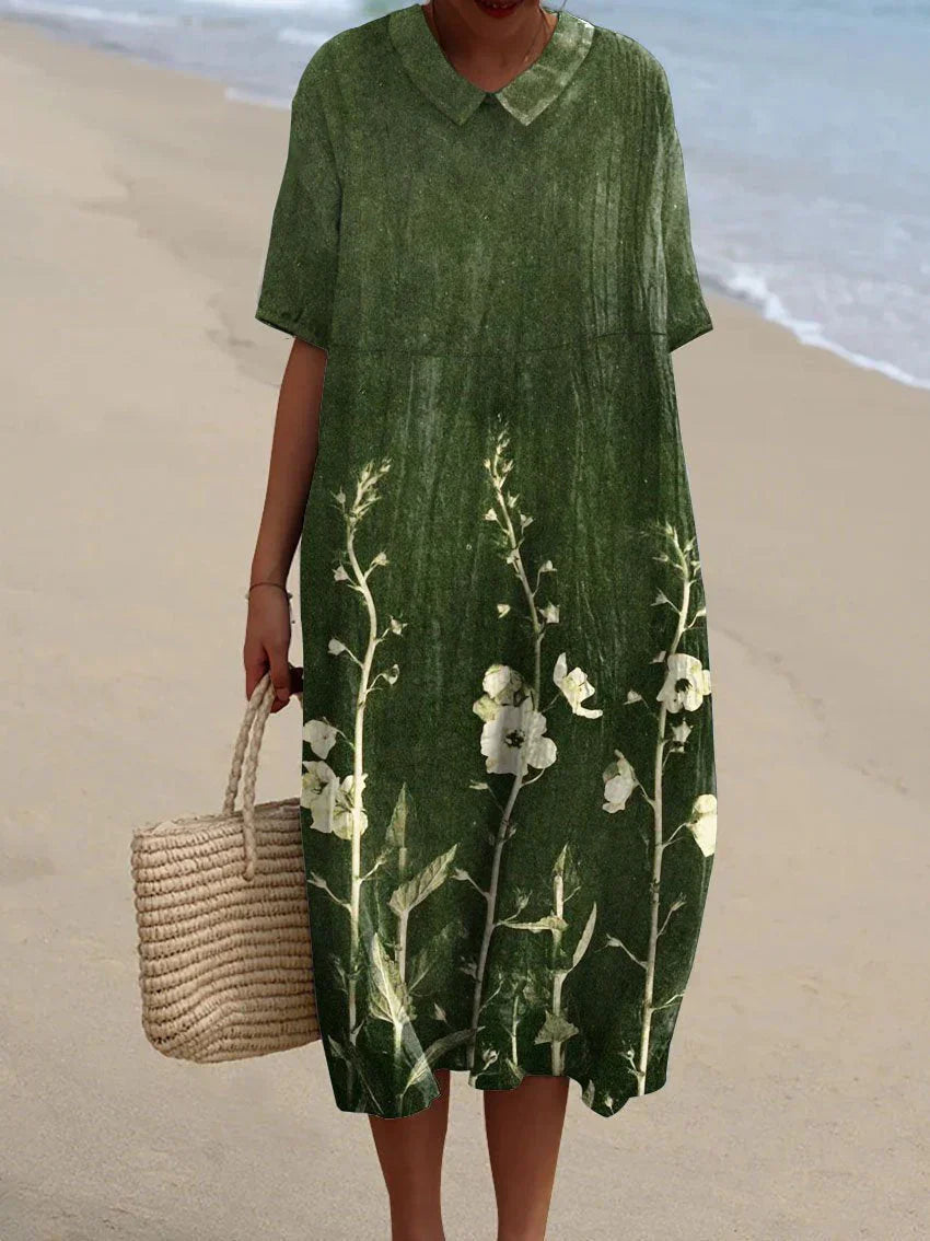 Zomerjurk Tess met bloemenprint, luchtige midi dress in kleurrijke bloemen, ideaal voor zonnige dagen met elegant design.