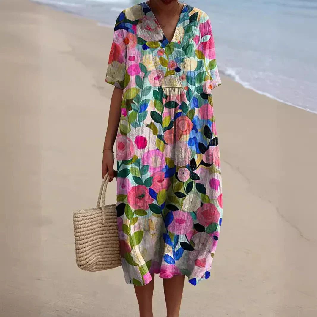 Zomerjurk Tess met bloemenprint, luchtige midi dress in kleurrijke bloemen, ideaal voor zonnige dagen met elegant design.