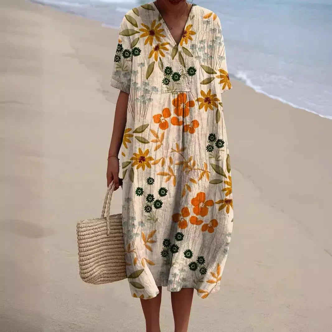 Zomerjurk Tess met bloemenprint, luchtige midi dress in kleurrijke bloemen, ideaal voor zonnige dagen met elegant design.