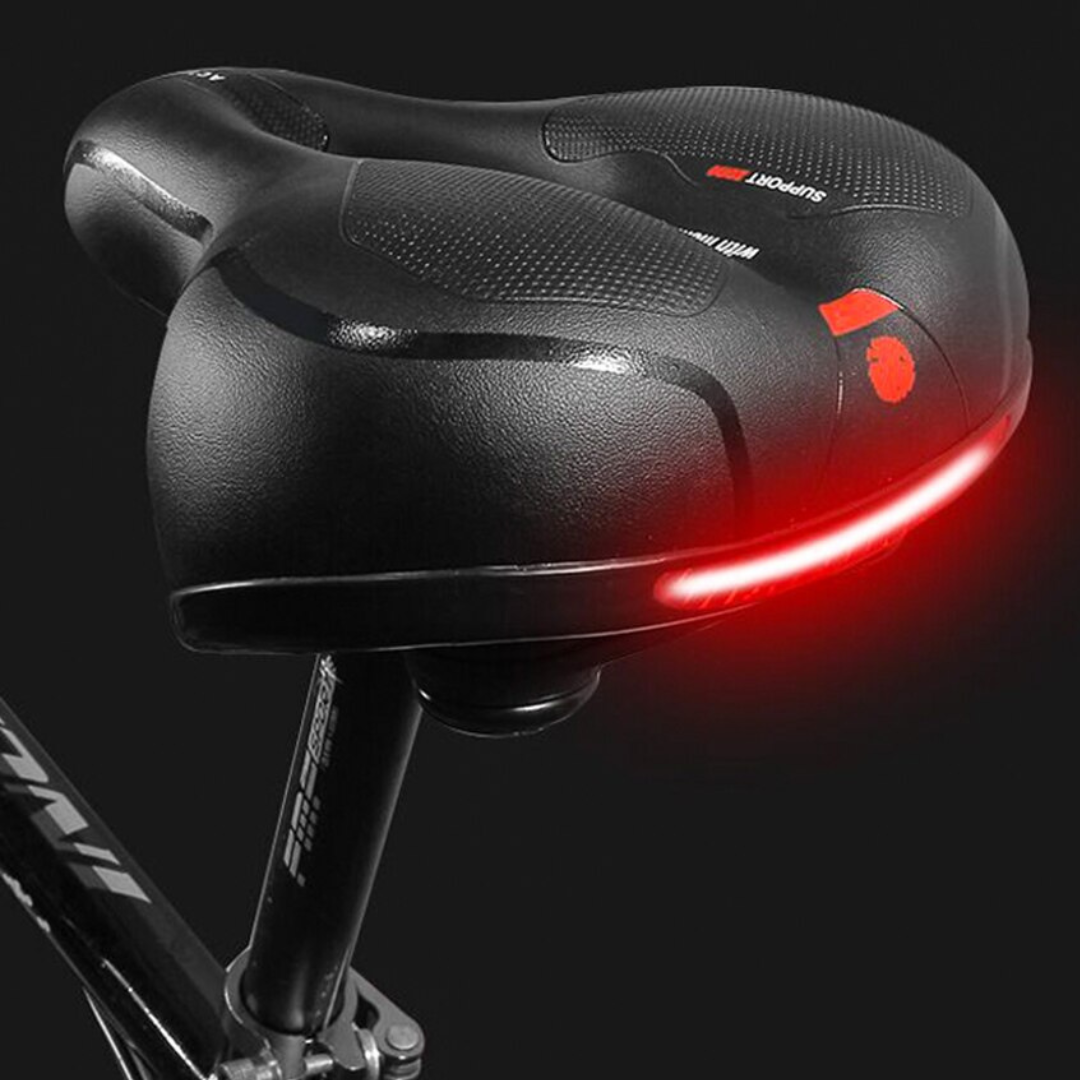 "Zwart ergonomisch fietszadel met universele pasvorm, schokabsorberende vering en comfortabel PE schuim voor lange ritten."