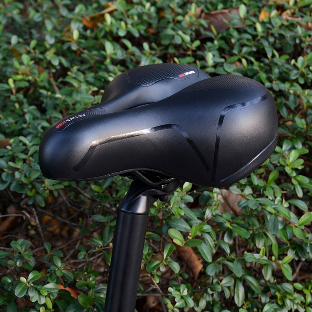 "Zwart ergonomisch fietszadel met universele pasvorm, schokabsorberende vering en comfortabel PE schuim voor lange ritten."
